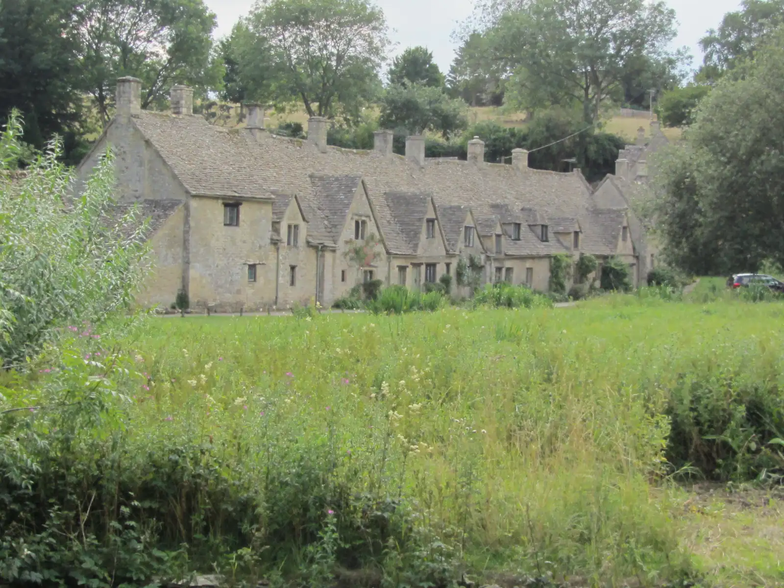 Arlington Row w Bibury widziane zza zielonej łąki